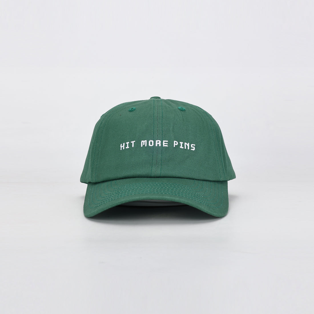 Grön Hitpin keps med texten "Hit more pins" på framsidan